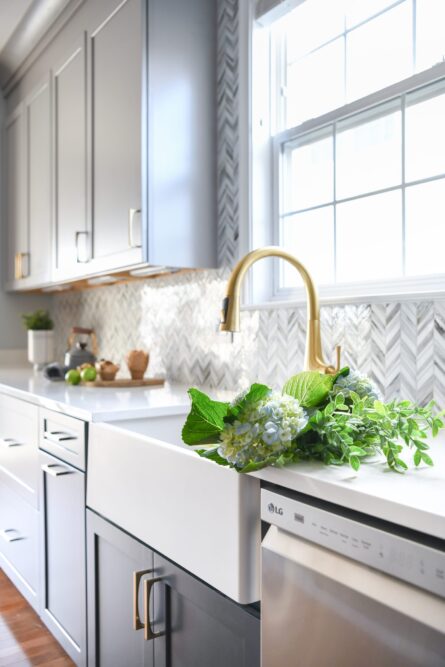 Photo of a kitchen design project in Ashburn VA featuring a soothing gray and blue color palette and quality hardware